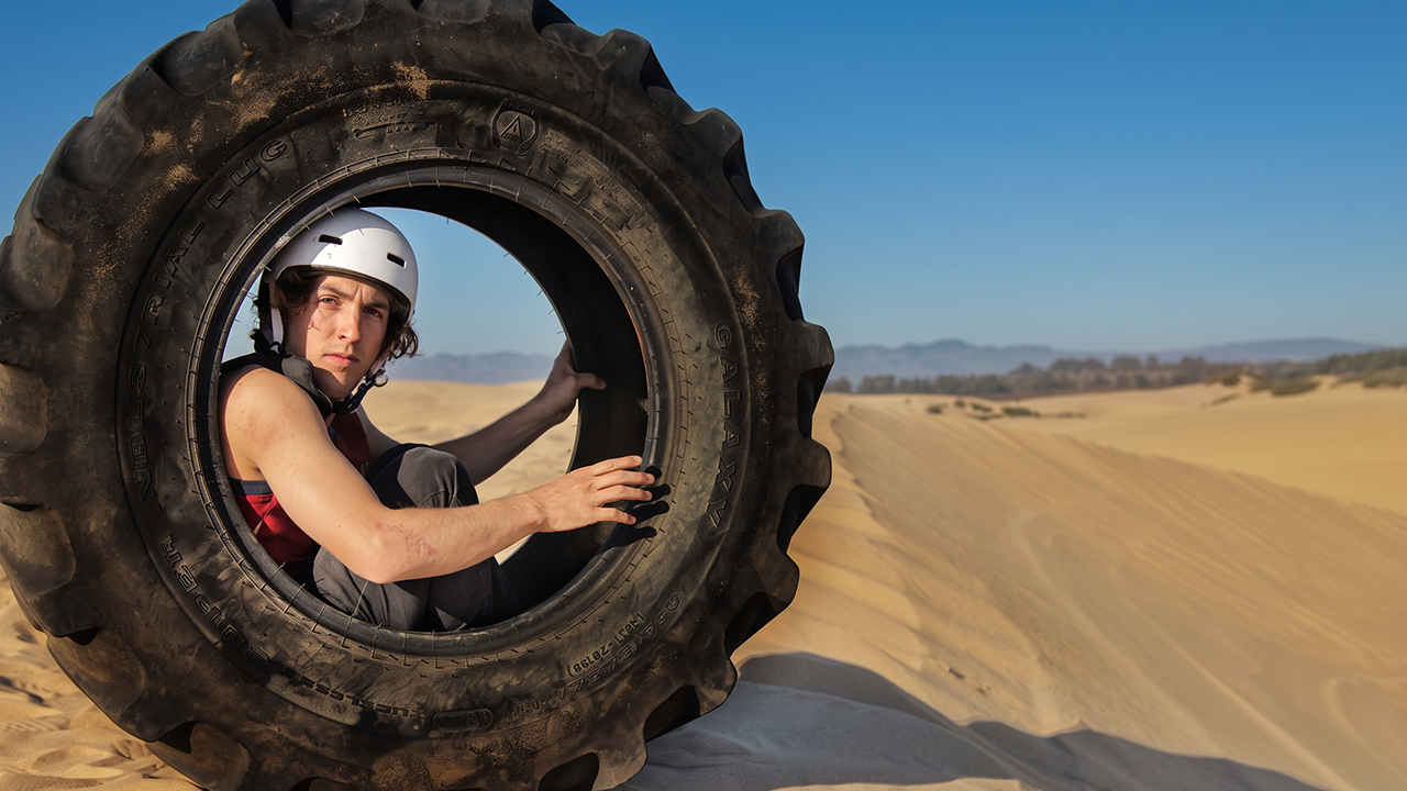 Giant tire ride down a sand dune ends in a terrifying roll