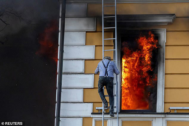 People were seen leaning out of windows as bright orange flames engulfed part of the building