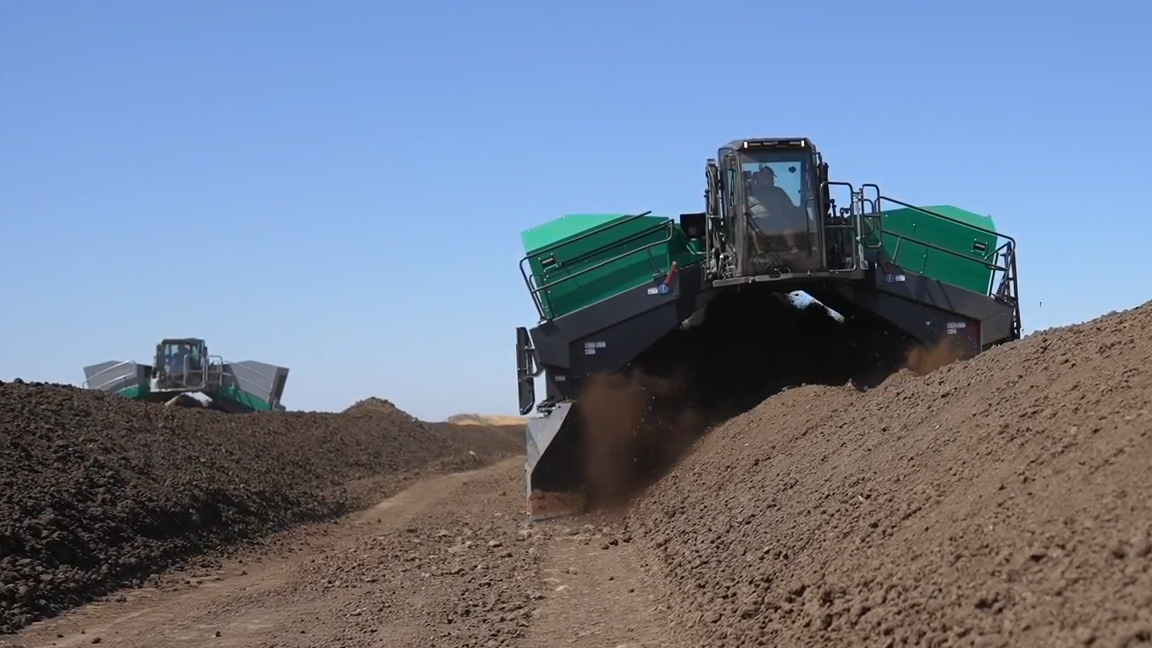 Heavy equipment processing huge compost windrows