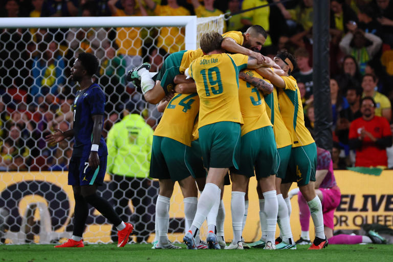 Australian players celebrate a goal by Connor Metcalfe during their international friendly soccer match against Brazil in Brisbane, Australia, on Tuesday, Sept. 29, 2026. (AP Photo/Tertius Pickard)