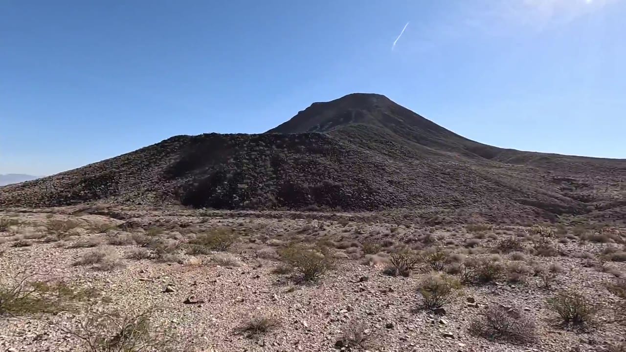 The mountain hid a sandy hollow. Someone had already left something inside.