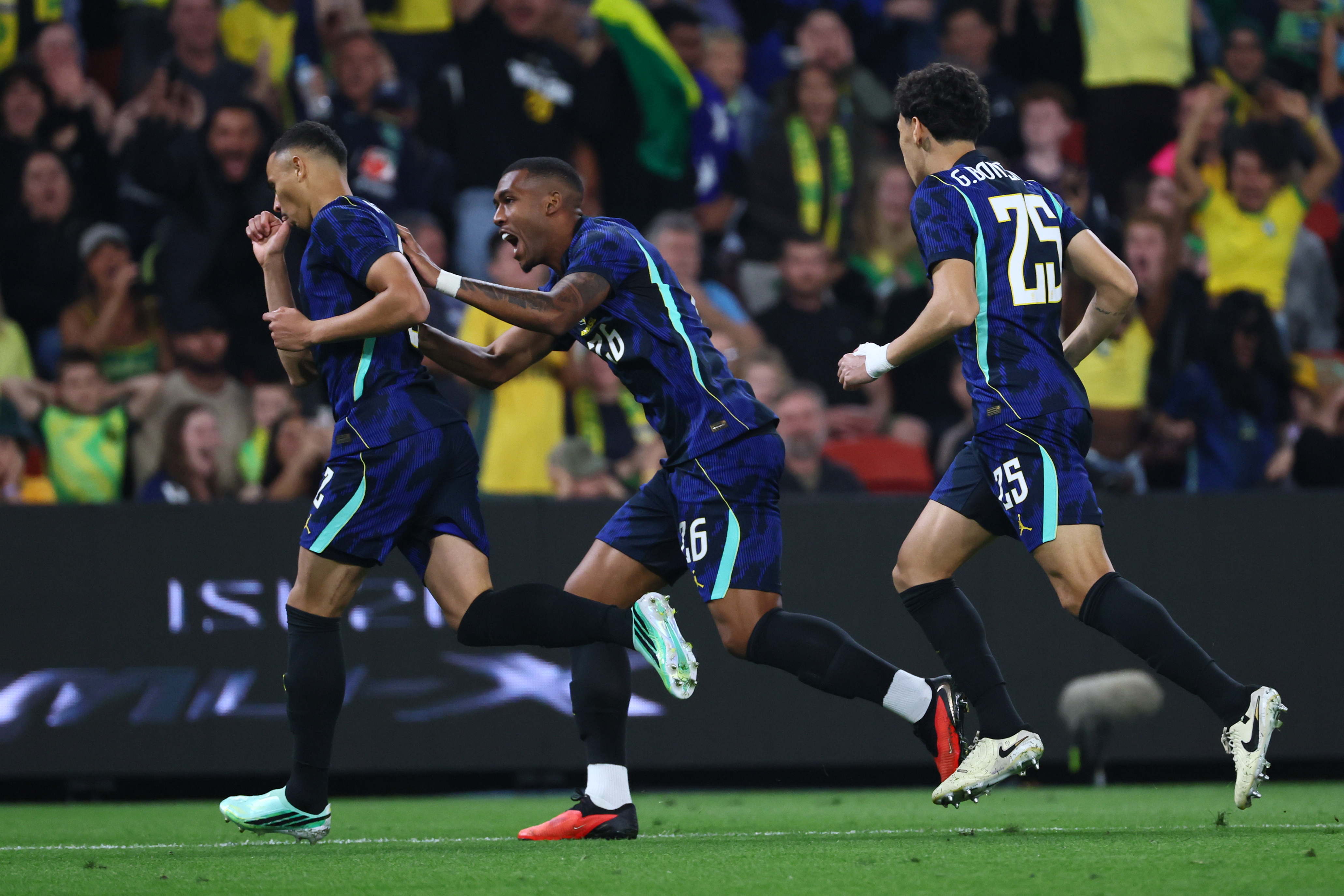 Brazil's Vanderson, left, celebrates with teammates Gabriel Bontempo, right, and Rayan after Vanderson scored a goal against Australia during their international friendly soccer match in Brisbane, Australia, on Tuesday, Sept. 29, 2026. (AP Photo/Tertius Pickard)