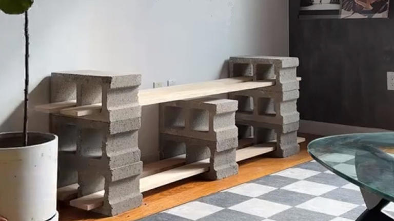 He turns concrete blocks and wood planks into a simple, durable TV stand