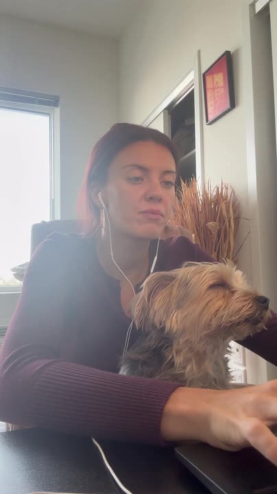 Sleepy dog can barely keep eyes open while sitting on owner's lap