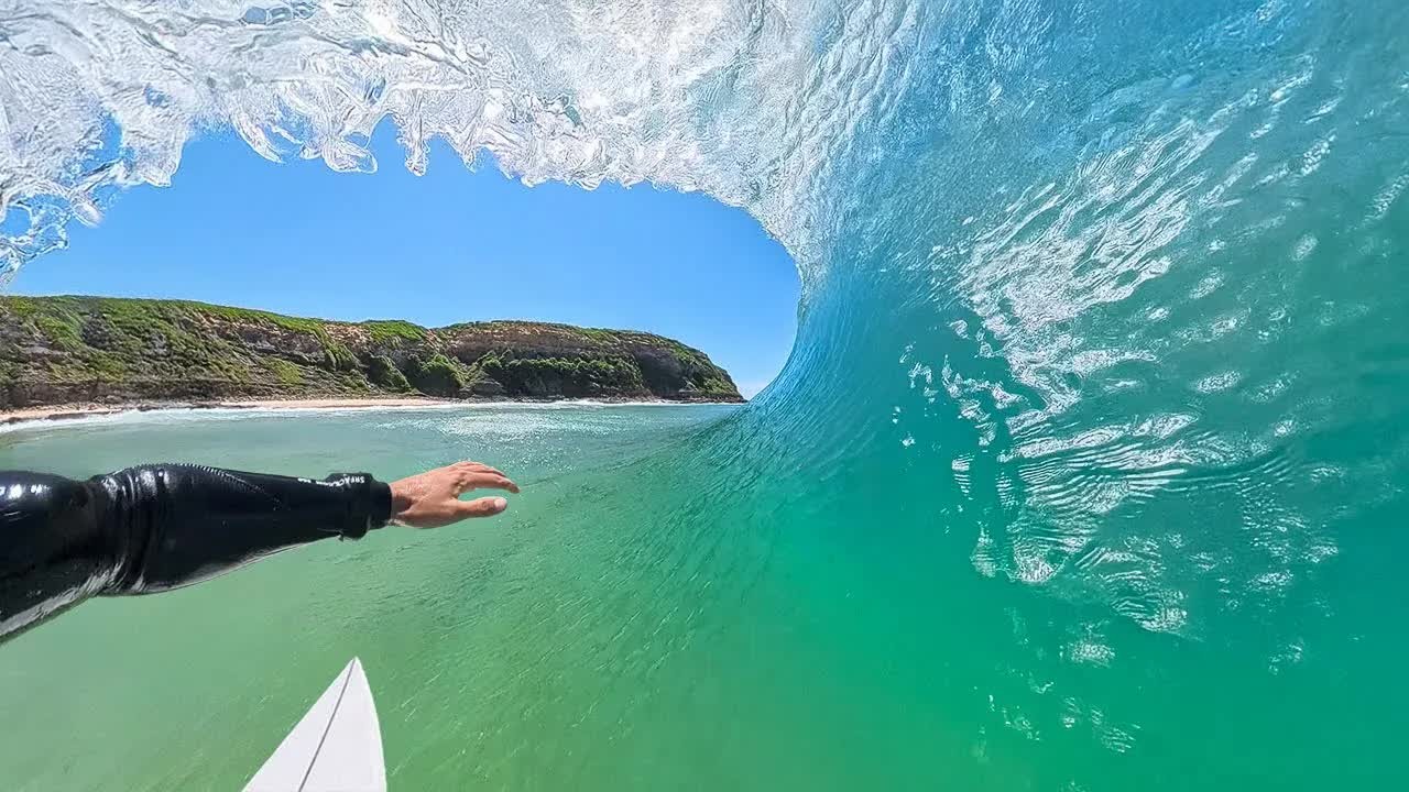 A surfer rides small barrels at a secluded Australian reef break