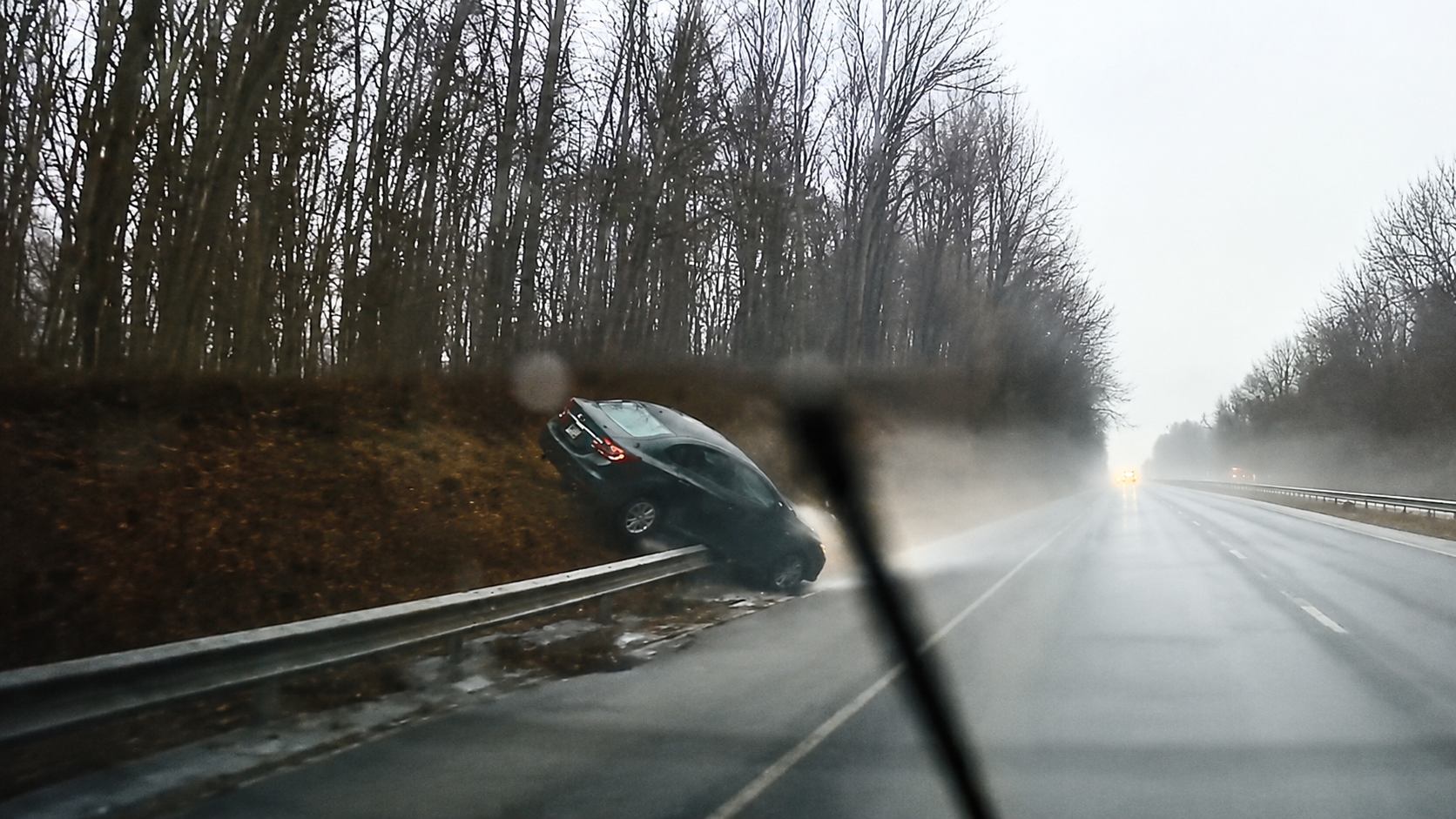 Driver lost control on ice, flipping him off the barrier - caught on ...