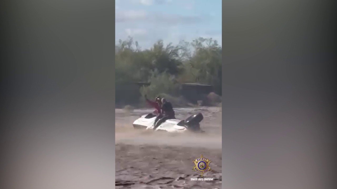 Helicopter crew hoists man to safety as floodwaters engulf overturned truck