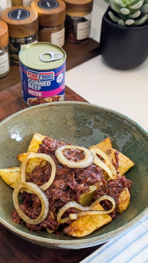 Bistek Tagalog corned beef over crispy potato wedges
