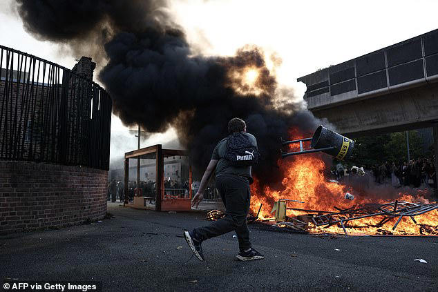 'Student' riots rock France as masked men torch schools and douse ...