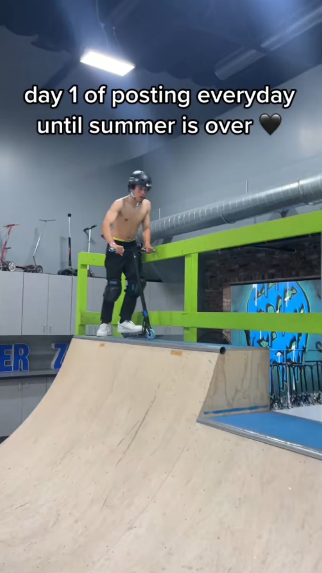 Freestyle scooter practice at an indoor skatepark