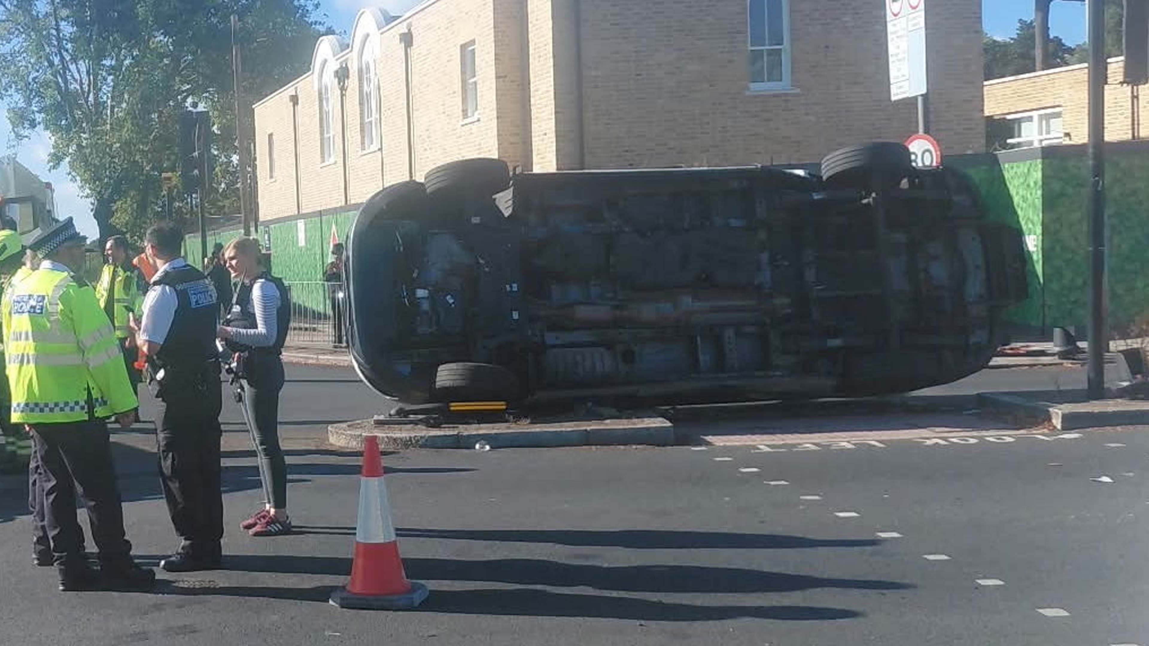 Police van flips on side after colliding with ambulance