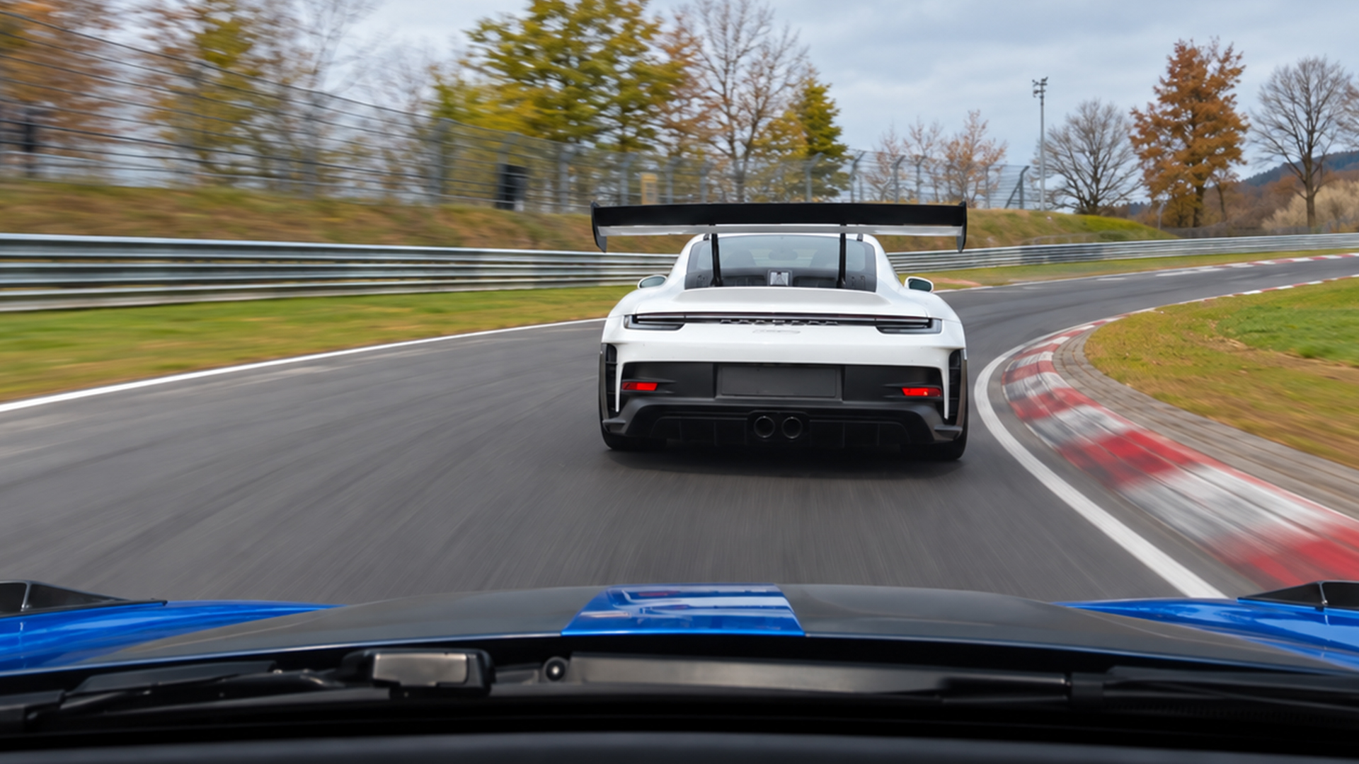Porsche race car leads a high-speed Nürburgring chase