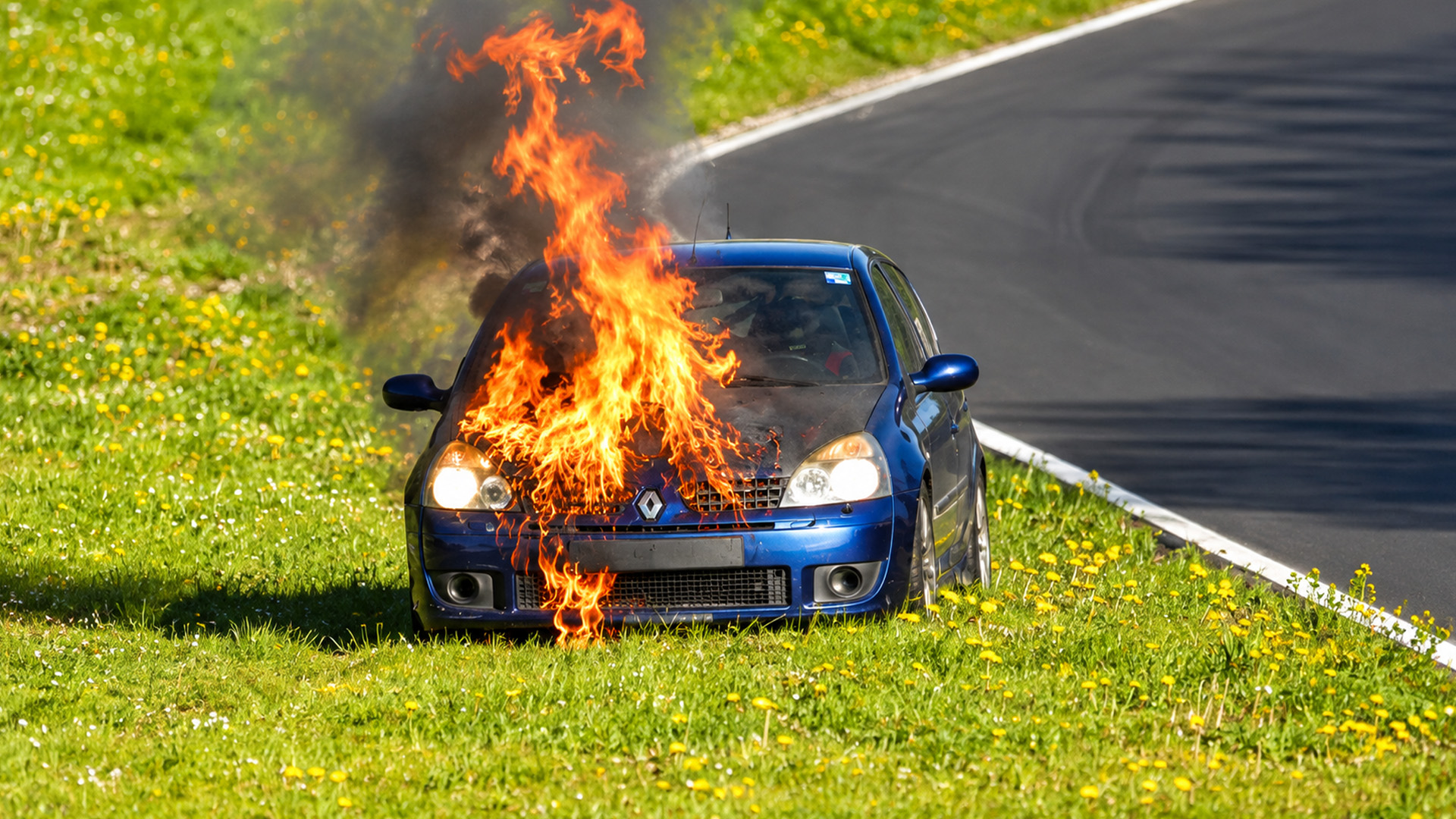 Small hatchback pulls over after catching fire on track