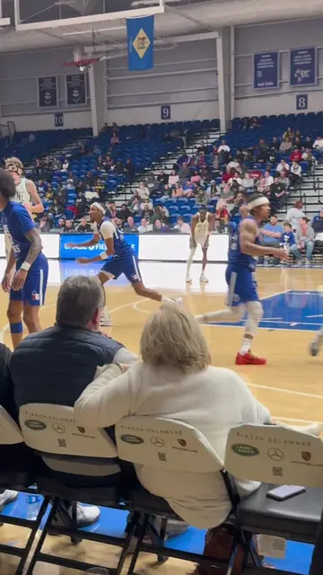Courtside view of a powerful Blue Coats fast break dunk