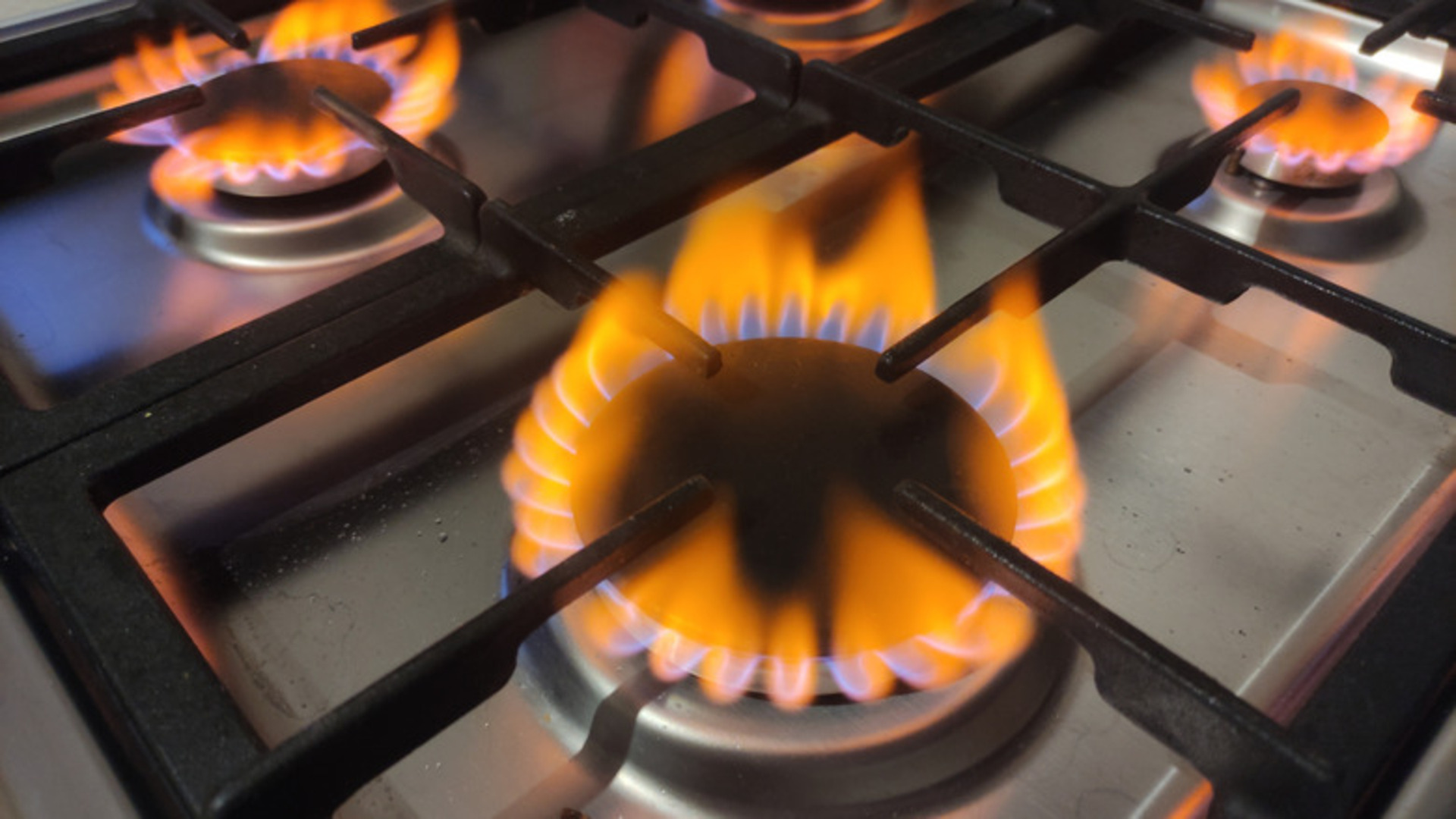 What does an orange flame on a gas stove mean?