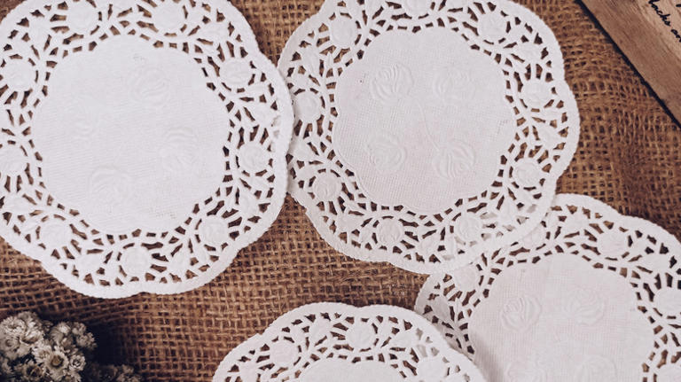 Turn paper doilies into a dainty ghost garland with vintage charm