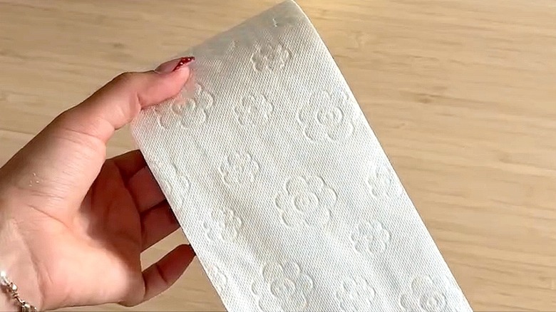 Woman uses toilet paper to transform cardboard into orchid-inspired ...