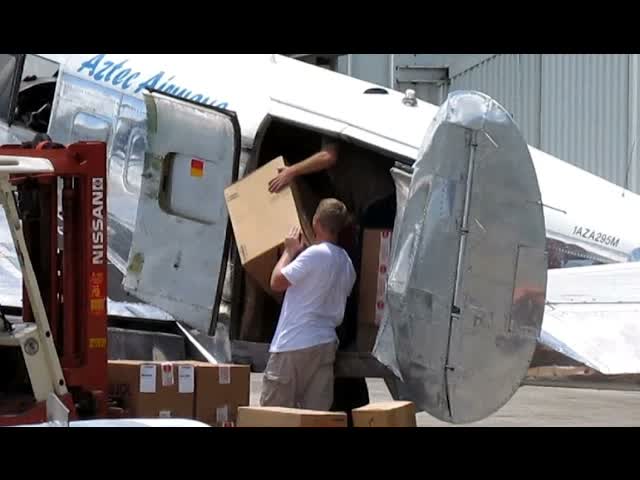 Aztec Airways Beechcraft 18 cargo loading & takeoff from FXE