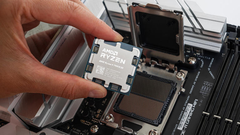 AMD Ryzen 9 7950X3D being inserted into motherboard socket