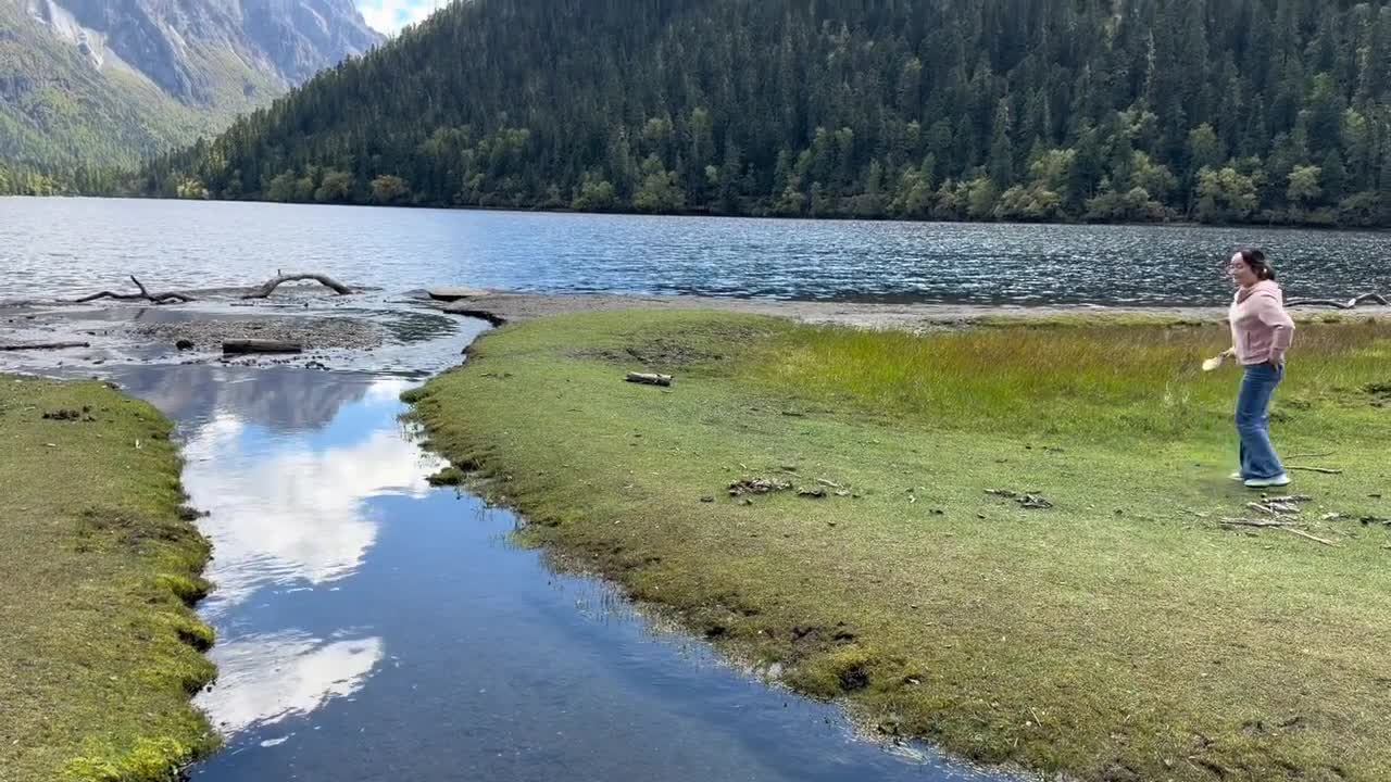 Woman falls into a water stream after missing a jump near a river in ...