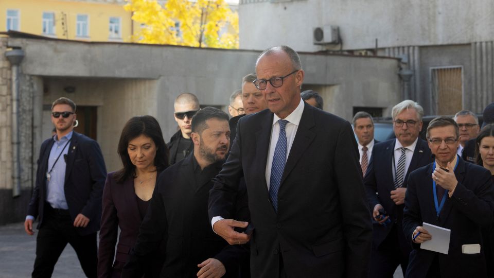 Ukraine's President Volodymyr Zelensky (left) and German Chancellor Friedrich Merz (right) inspect a damaged building in Kyiv on October 4. - Tetiana Dzhafarova/AFP/Getty Images