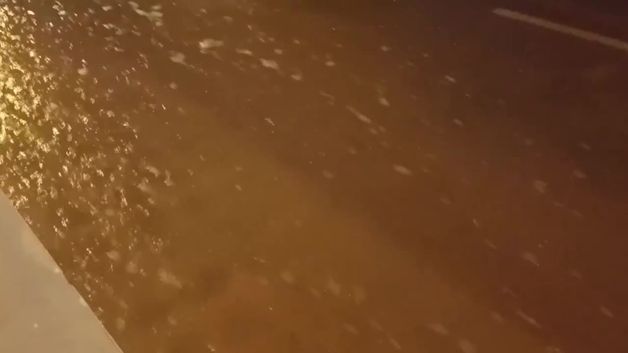 Fast-flowing water rushes along street in Spain