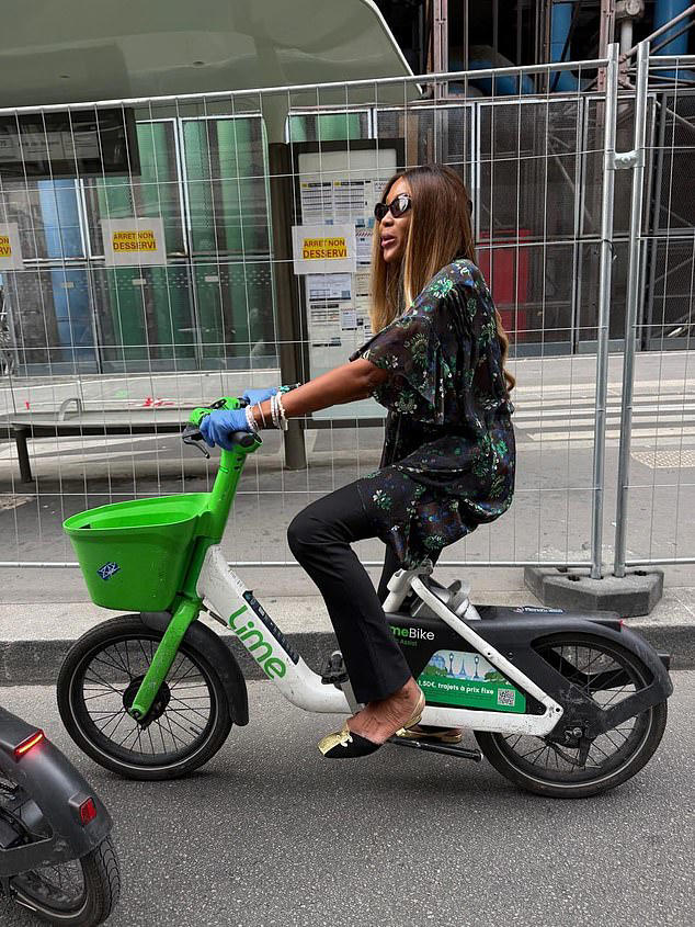 Self-confessed germaphobe Naomi Campbell wipes down a Lime bike and ...