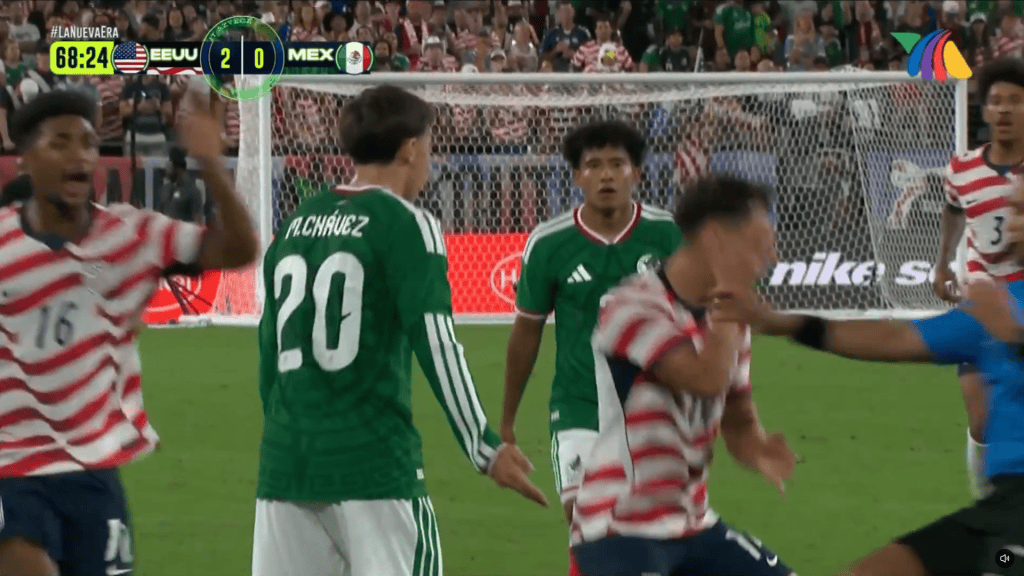 Sebastian Berhalter holds his cheek and falls to the ground after Mateo Chavez slapped him with both hands. X @roger21footy