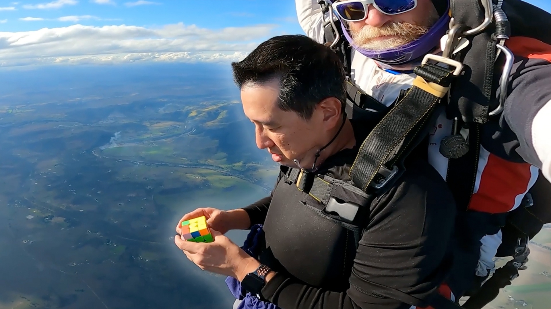 Most rotating puzzle cubes solved in a single skydive - 10 by Ming Dao Ting