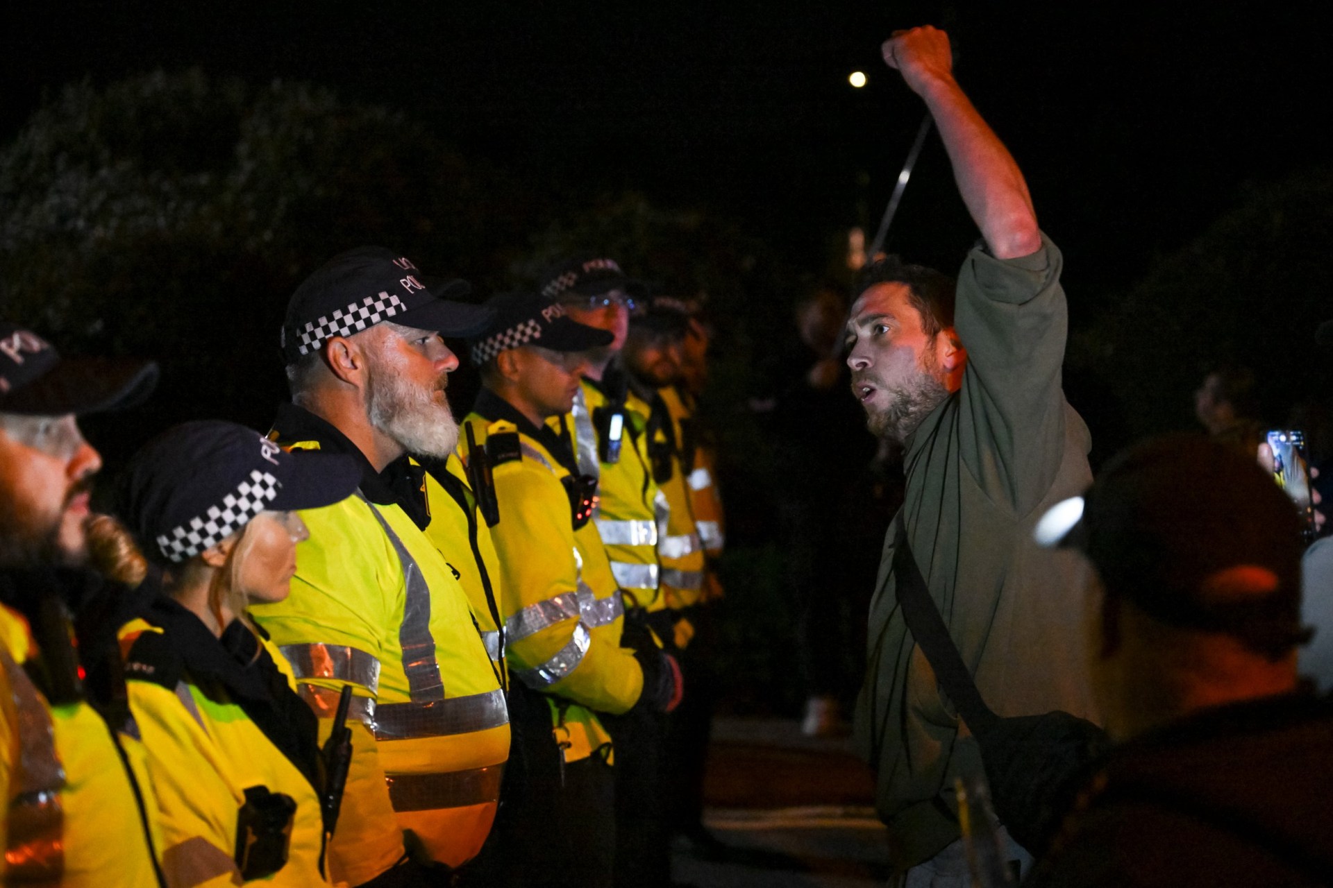Police break up 100 masked patriots delivering anti-migrant message to ...