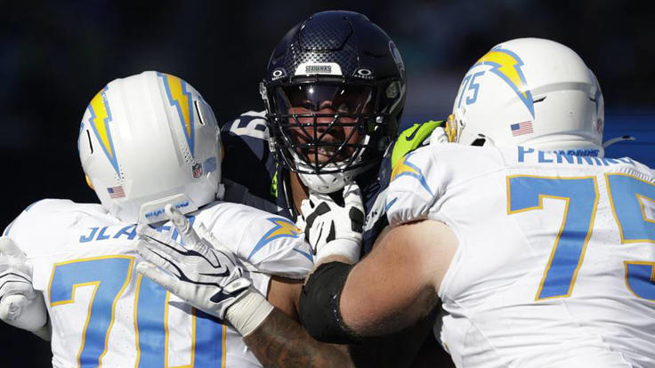 Oct 4, 2026; Seattle, Washington, USA; Seattle Seahawks defensive tackle Leonard Williams (99) rushes against Los Angeles Chargers offensive tackle Rashawn Slater (70) and Los Angeles Chargers guard Trevor Penning (75) during the first half at Lumen Field. | IMAGN IMAGES via Reuters Connect