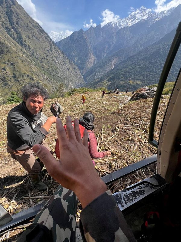 Nepal Army helicopter rescues people from areas affected by flooding of Budhi Gandaki River following a dry landslide in Chumnubri village, Gorkha district, Nepal, in this handout obtained by Reuters on October 11, 2026. Nepal Army/Handout via REUTERS