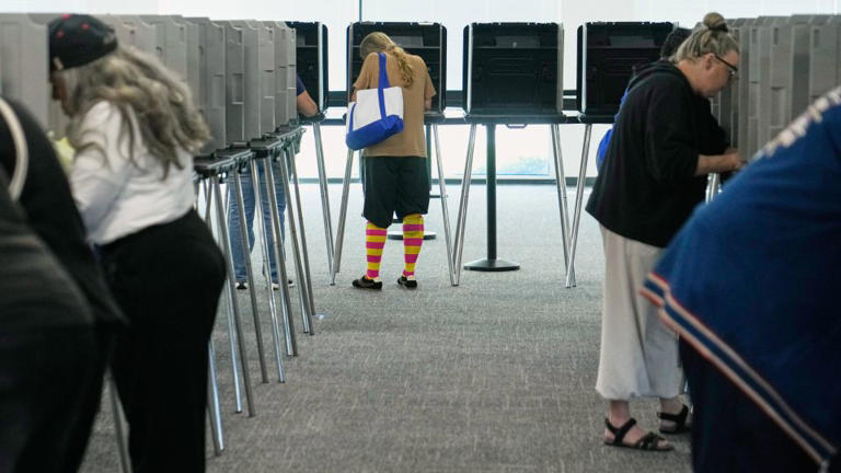 Voters fill in their ballots in privacy booths during early in-person voting in Cleveland on Wednesday, Oct. 7, 2026. - Sue Ogrocki/AP