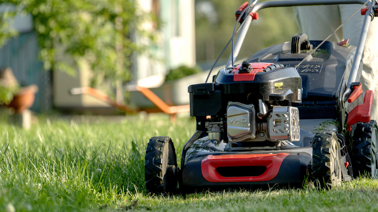 Upcycle old wood pallets into a lawn mower storage solution with a ...