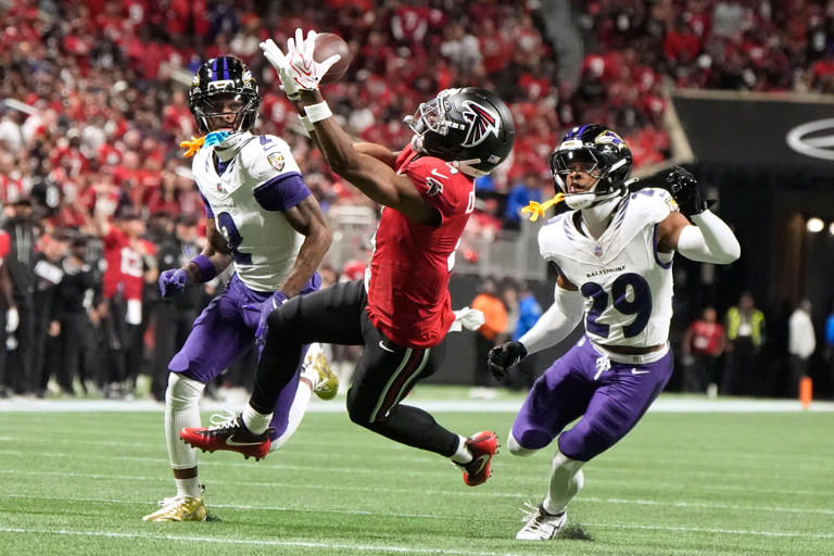Atlanta Falcons wide receiver Jahan Dotson, center, catches a pass between Baltimore Ravens cornerback Nate Wiggins (2) and cornerback Chandler Rivers (29) during the first half of an NFL football game, Sunday, Oct. 11, 2026, in Atlanta. (AP Photo/Mike Stewart)