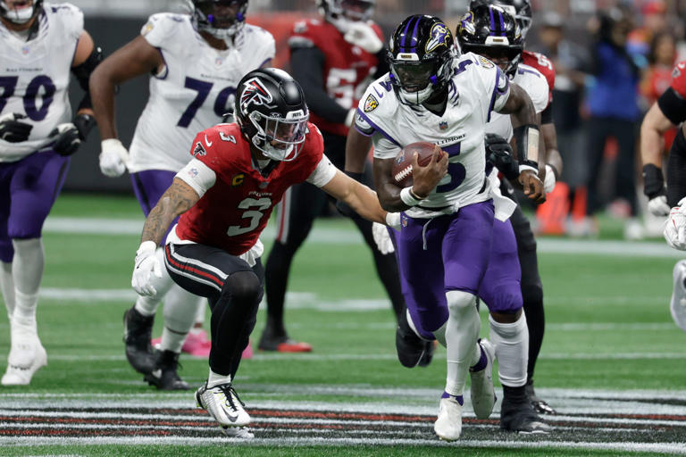Baltimore Ravens quarterback Tyler Huntley (5) runs from Atlanta Falcons safety Jessie Bates III (3) during the first half of an NFL football game, Sunday, Oct. 11, 2026, in Atlanta. (AP Photo/Erik S. Lesser)