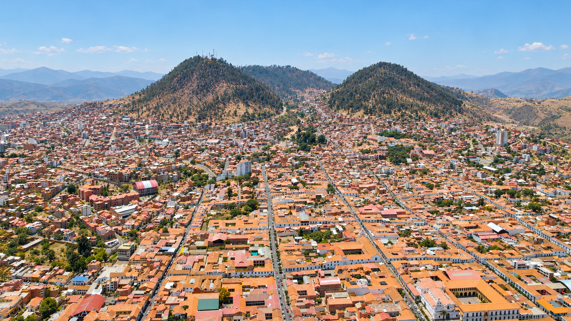 Thousands of red rooftops beneath Bolivia's mountains