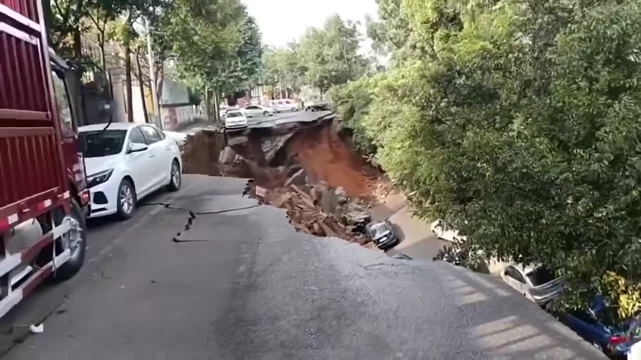 Road swallows 15 vehicles as ground gives way in China