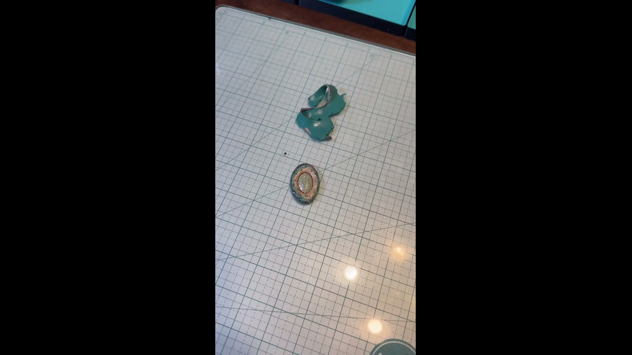 Polymer clay artisan shapes clay into patterned earrings