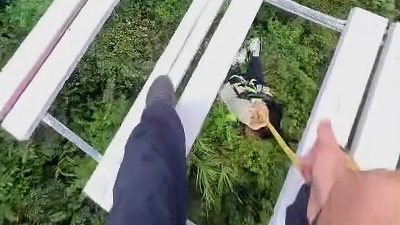 Terrifying moment man pulls fallen daughter back onto suspended bridge ...