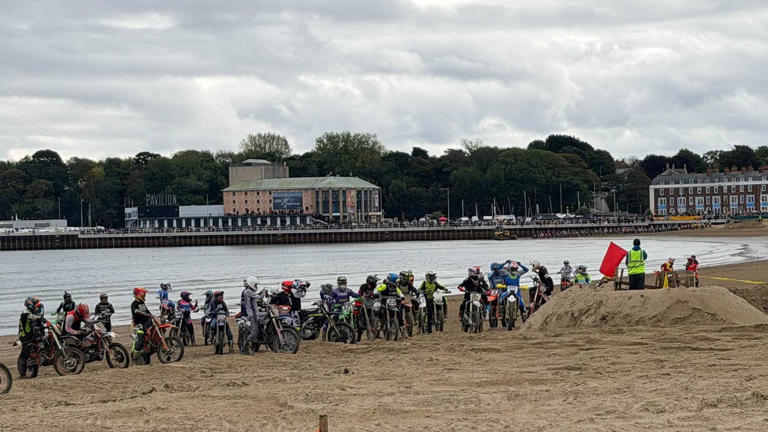 Thousands line promenade for beach motocross
