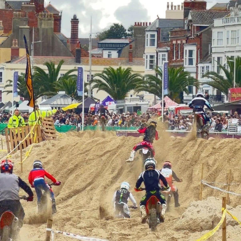 Thousands line promenade for beach motocross