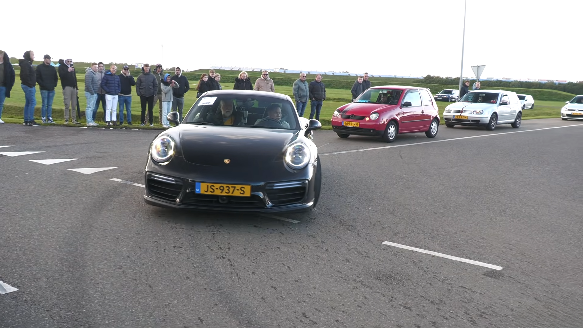 Modified cars and supercars leave Assen Circuit in a convoy