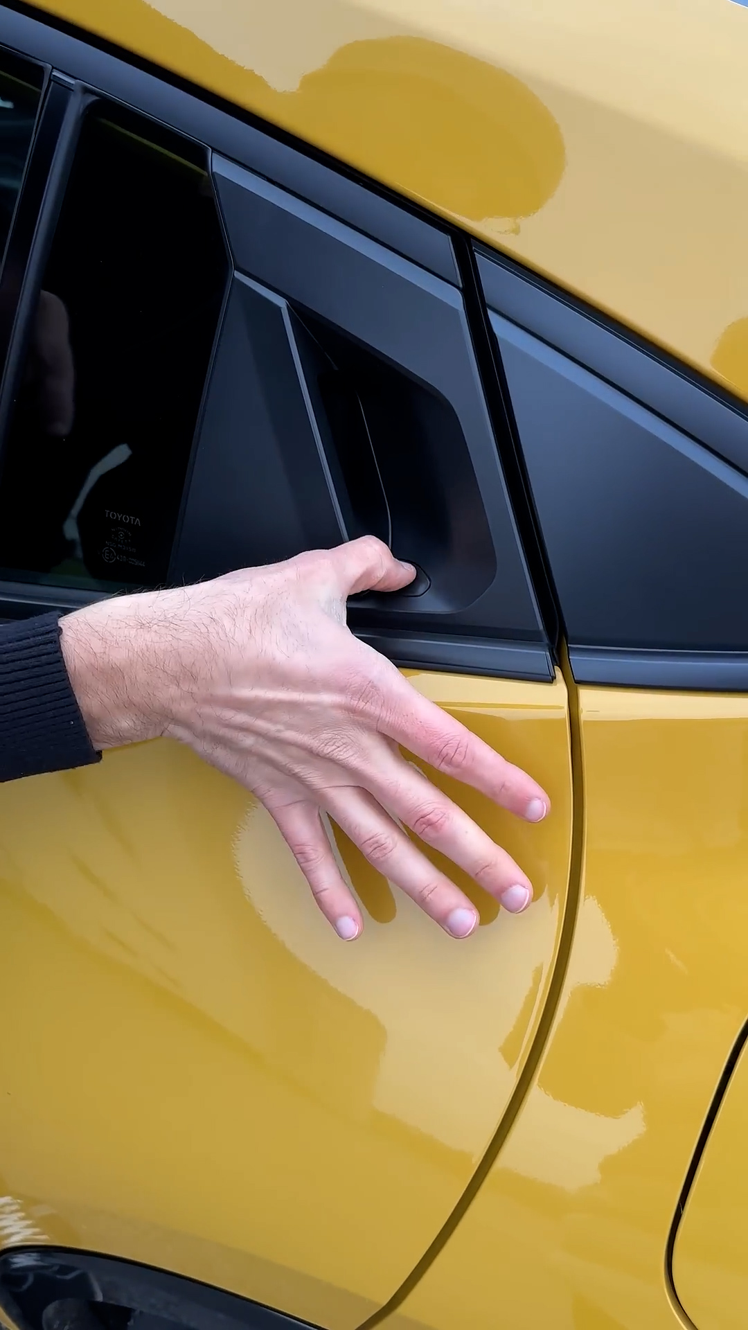 Toyota Prius features an electric door release button and a manual door ...