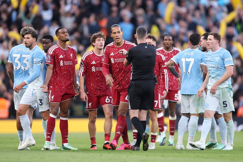 Liverpool players react toward referee Chris Kavanagh after Ryan Gravenberch is sent off