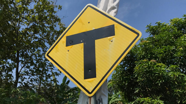 What does the yellow road sign with a black letter T on it mean?