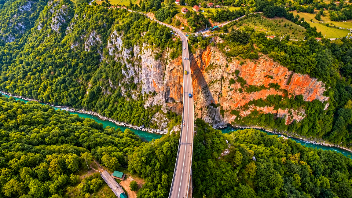 An incredible bridge surrounded by lush forests and rocky cliffs