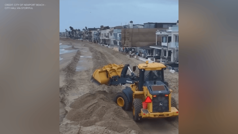 Crews in Newport Beach rush to build new sand berms amid high surf ...