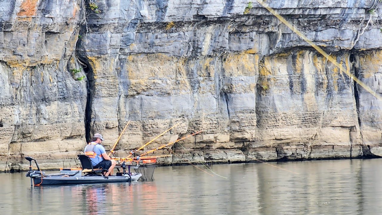 Kayak fishing the deep water below rock cliffs