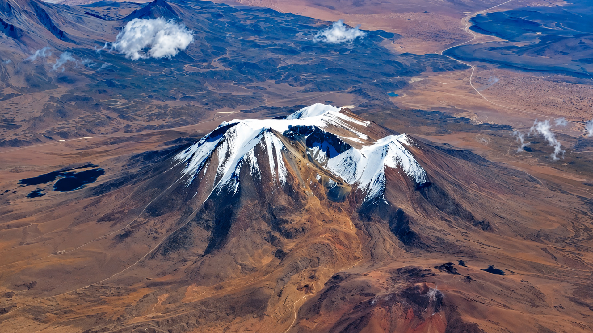 Why are Bolivia's volcanoes covered in snow?